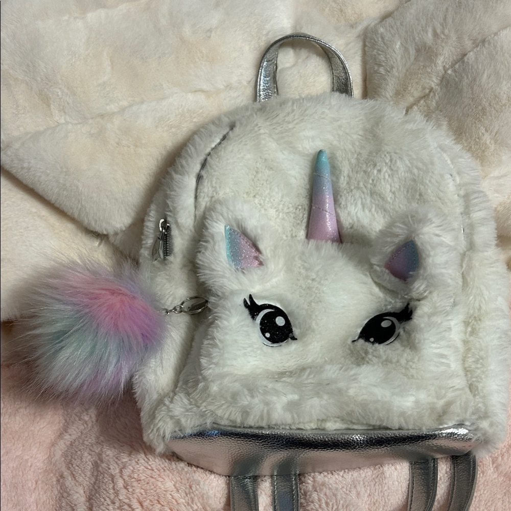 SOLD. 
Justice White Unicorn Backpack with Silver and Pastel Colors